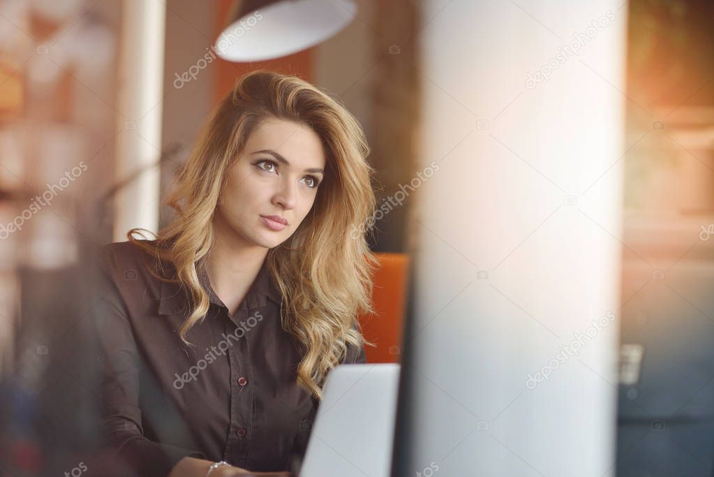 Portrait of cheerful employer of business enterprise enjoying creative working process in modern office indoors