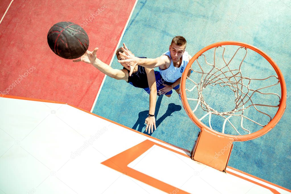 High angle view of basketball player dunking basketball in hoop