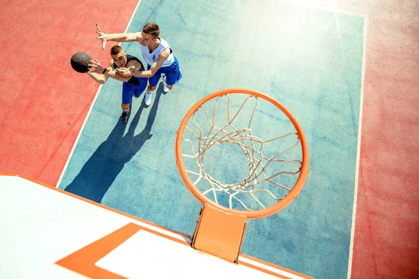 Vista de ángulo alto del jugador de baloncesto que zambulle en el aro — Foto de Stock