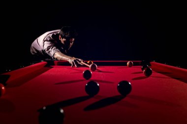 A man with a beard plays a big billiard. clipart