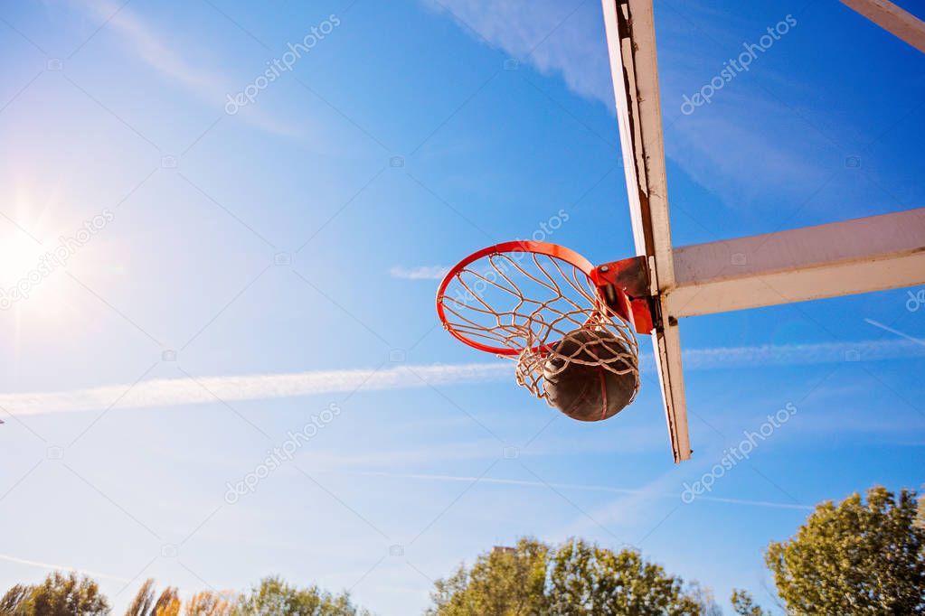 basketball close up, basketball bal in hoop at sunny day