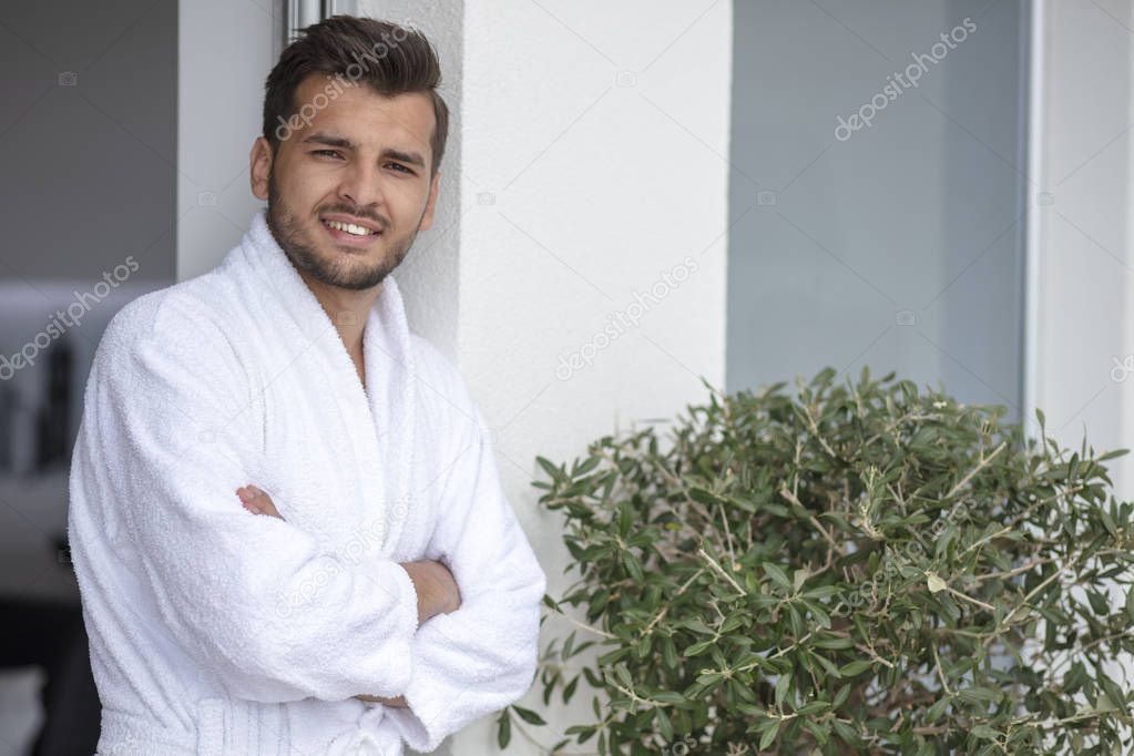 Morning portrait of handsome young man in bathrobe
