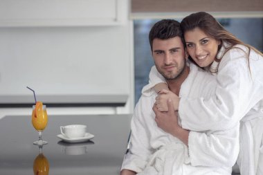 Portrait of a man and his wife in the kitchen while having breakfast clipart