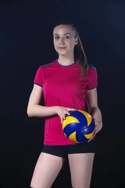 Indoor young volleyball woman player isolated on dark background — Stock Photo, Image