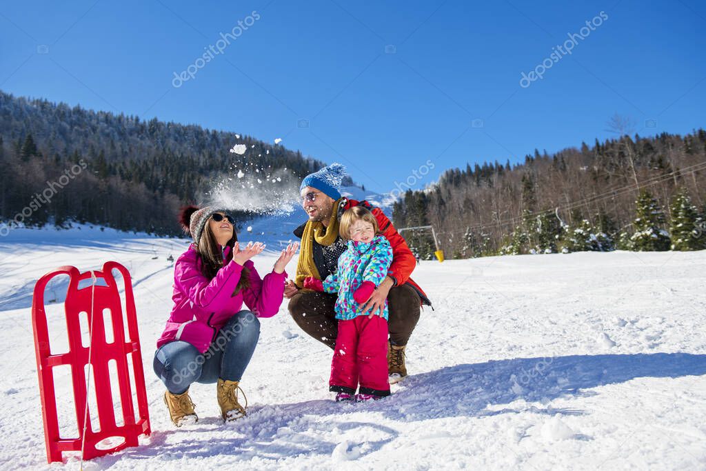 Happy Family In Snow Riding On Sledge.