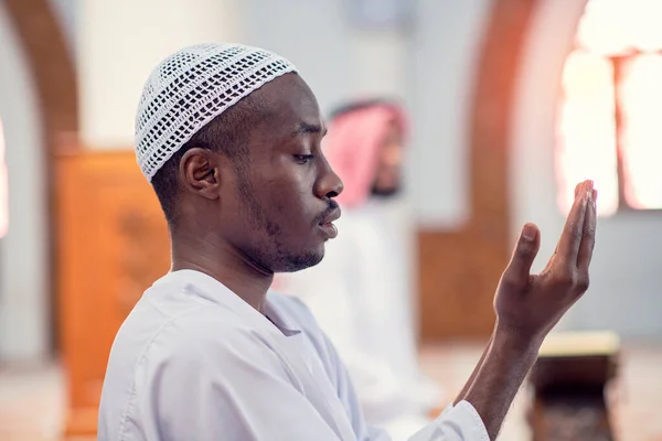 Religious black muslim man praying inside the mosque — Stock Photo, Image