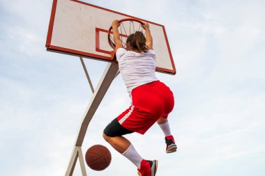 Sokak sahasında basketbol oynayan kadınlar. Kadın sokak oyuncusu basketbol maçında smaç basıyor..