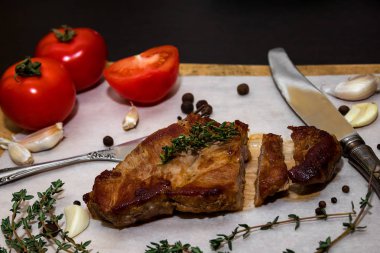 Baharatlar ve sebzeler ile ahşap bir eski kesme tahtası üzerinde sulu biftek biftek. Siyah bir arka plan üzerinde restoran menüleri için metin tasarım için. Gıda arka plan.