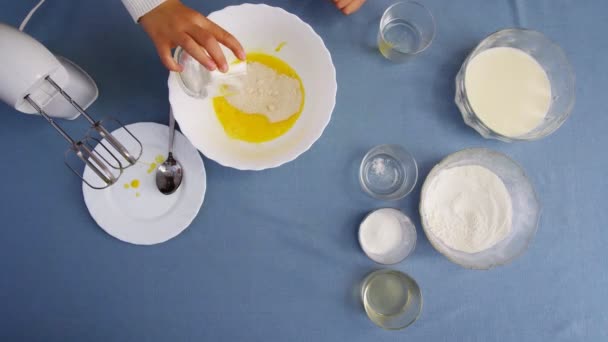 반죽을 만드는 소녀의 맨 위에 있는 모습. 반죽 과 전기 믹서를 섞는다. 집에서 요리하는 모습. — 비디오