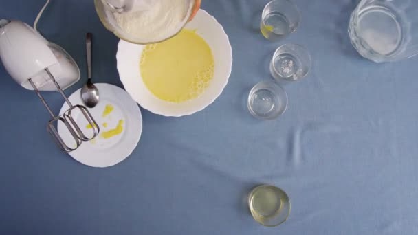 Top view of a girl making dough. Mixing dough with electric mixer. Cooking at home. — Stock Video