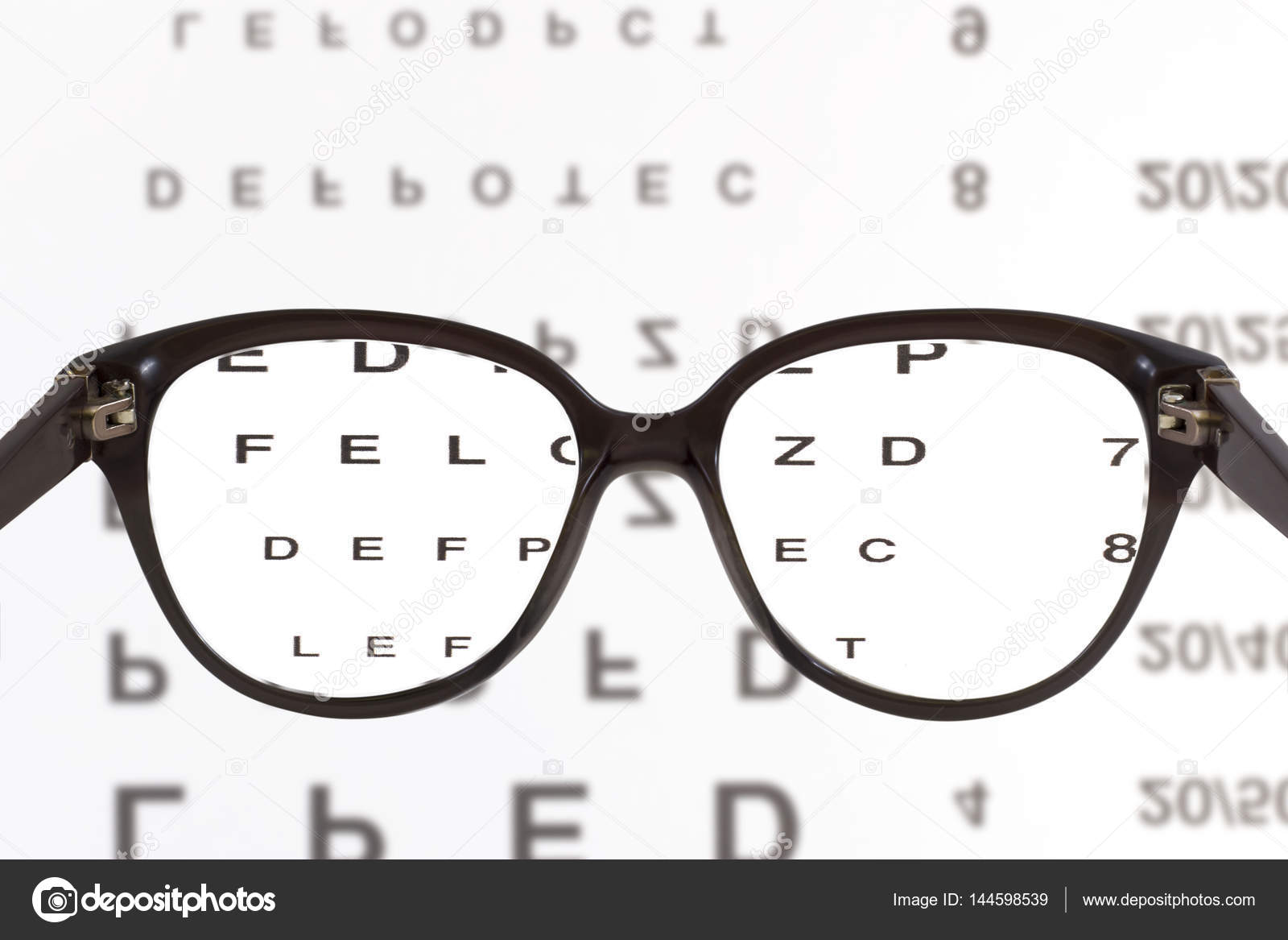 Eye glasses on eyesight test chart — Stock Photo © juriskraulis 144598539