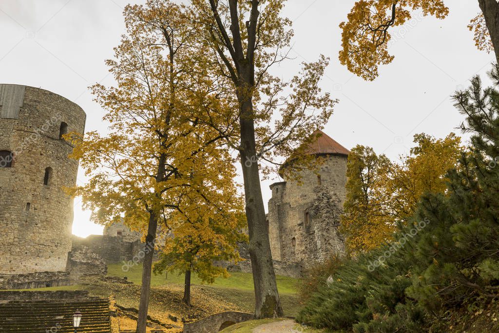 Autumn park with old castle ruins in Cesis town