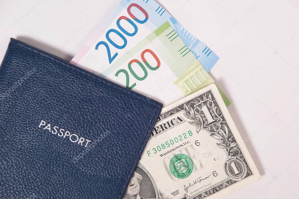 blue passport with dollar bills and Russian rubles, or euros on a white background