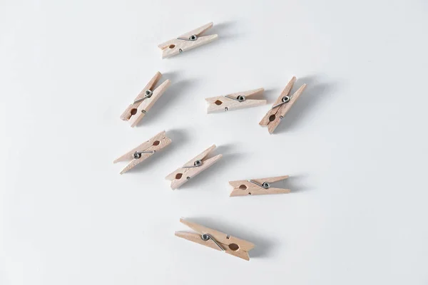 Small Wooden Clothespins Lie White Background — Stock Photo, Image