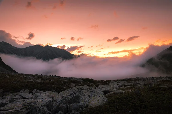 粉红落日的天空笼罩着云彩背景的高山峡谷 — 图库照片