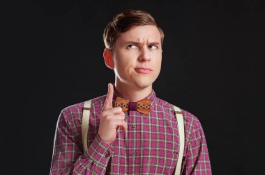 Vintage gömlek papyon siyah arka plan ayakta iken kaldırdı parmak tutmak saç modeli ile düşünceli ciddi akıllı bilimsel adam portresi. Duygular insanlar eğitim iş moda kavramı