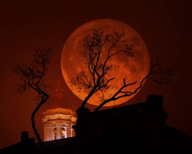 Kan kırmızı Supermoon bir kilise ve bir ağaç kötü havada