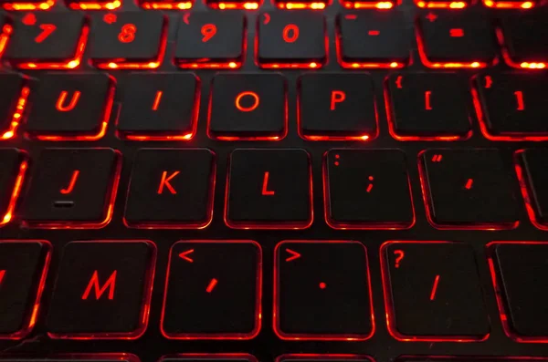 Black laptop keyboard with red backlighting keys — Stock Photo, Image