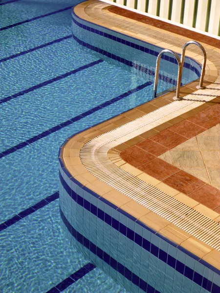 Swimming pool with stair at hotel close-up.