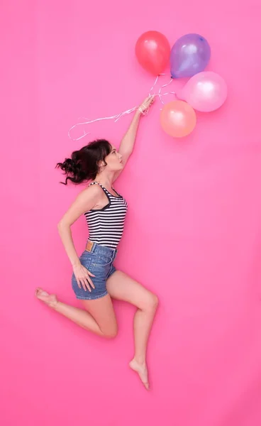 Young female is playing with balloons. Stock Picture