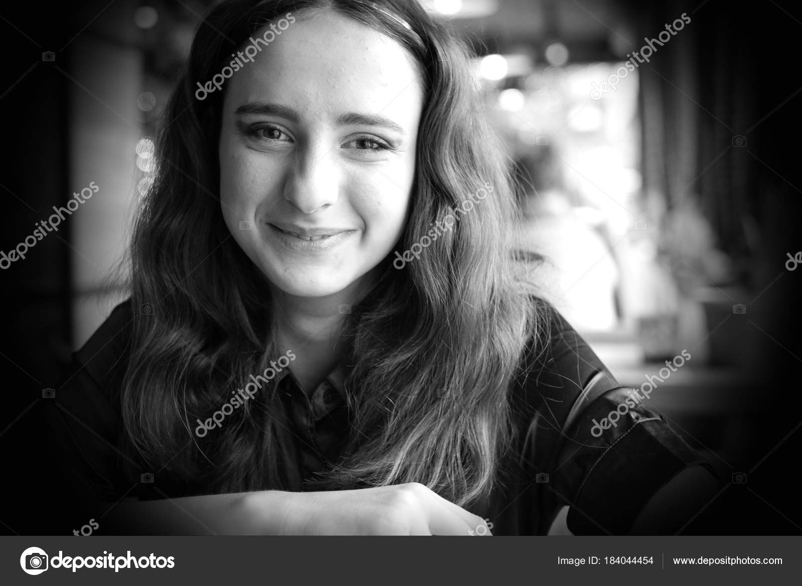 Portrait Of A Smiling Long Haired Girl In A Brown Blouse A