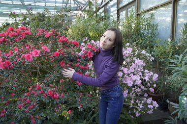 woman posing in greenhouse, azalea
