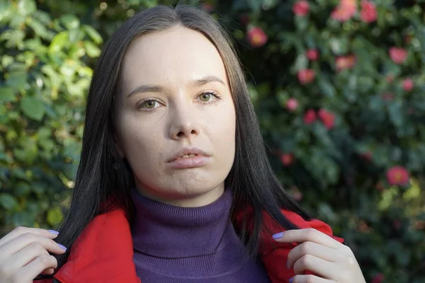 Face of young brunette woman in red — ストック写真