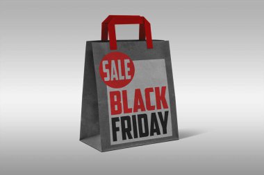 Black Friday Shopping Concept: Black Shopping Bag On light grey 