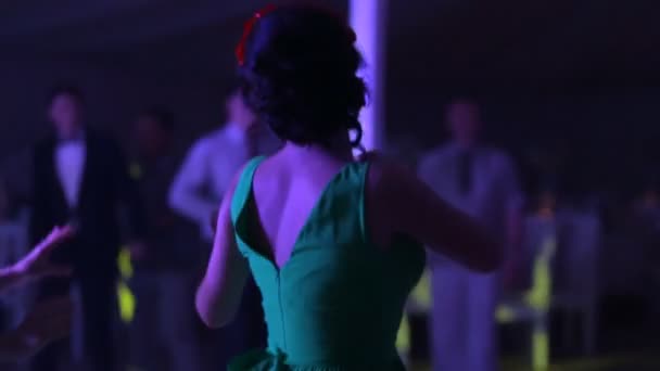 Lidé tančí v tmavé společenský sál pro svatební hostinu. — Stock video