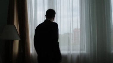 Giyinmek ve onun düğün gününde penceresine bakarak ciddi genç nişanlısı yakın çekim .