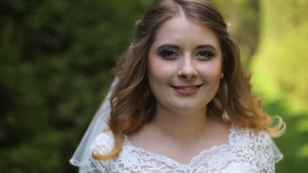 Elegant bride walking in the park. — Stock Video