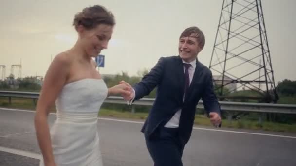 Bride and groom running at the rain — Stock Video