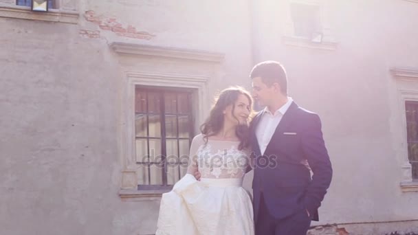 Bride and groom walking through the old town — Stock Video