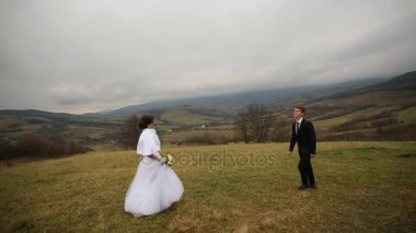 Gelin ve damat dağlar backgroung üzerinde. Güzel doğa. Düğün çifti.