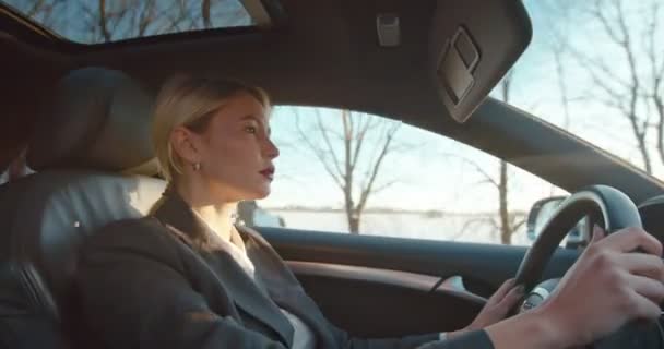 Caucasian good looking young woman in business style driving a car, being nervous, talking to herself and pushing the signal button. — Stock Video