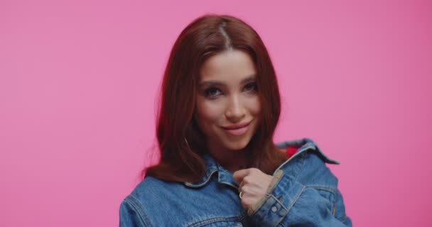 Fashion portrait of classy beautiful brunette. Model with smooth healthy skin and nude make-up looking and smiling at camera. Close up of girl with sensetive lips in pink background. — Stock Video © ihorvsn@gmail.com #355158644