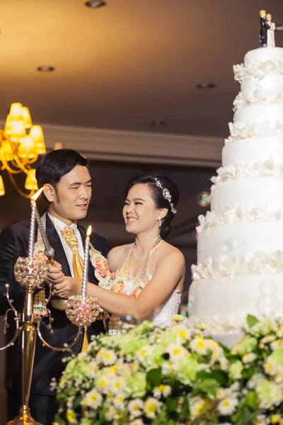 Наречена і наречений ріжуть торт для святкування на своєму весіллі — стокове фото