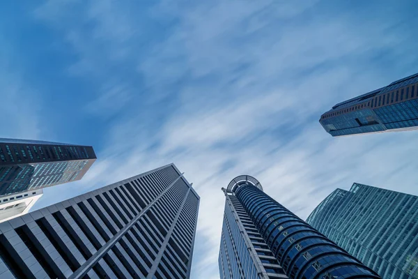 Business buildings skyline looking up with blue sky — Stock Photo, Image