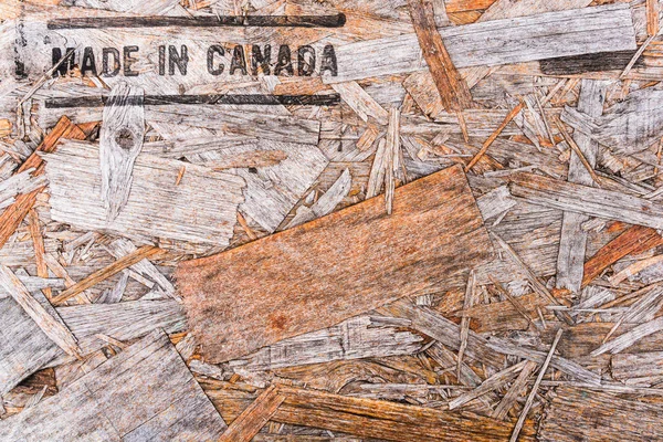 Made in Canada text on recycled wood board