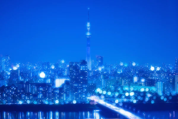 Tokió város éjszakai háttér életlenítés Bokeh fények — Stock Fotó