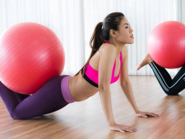 Beden eğitimi dersinde uygun topu ile egzersiz yaparak kadınlar