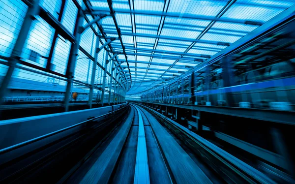 Comboio em movimento na cidade ferroviária com borrão de movimento — Fotografia de Stock