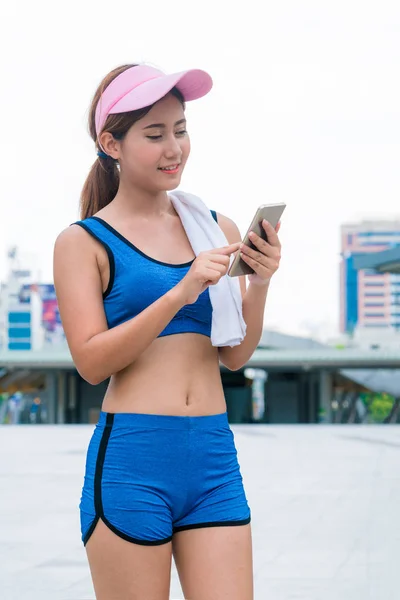 Sport woman runner using smartphone