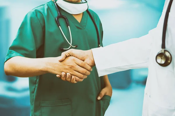 Doctors shaking hands. Medical people teamwork.