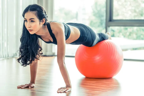 Frau macht Übungen mit fittem Ball in Fitnessstudio — Stockfoto