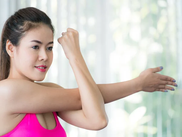 Sporty woman doing arm stretching — Stock Photo, Image