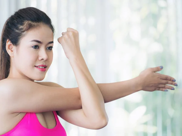 Sporty woman doing arm stretching — Stock Photo, Image