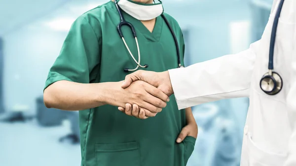 Doctors shaking hands. Medical people teamwork.