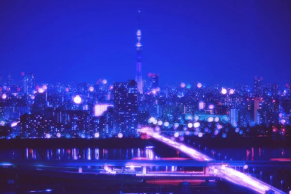 Stad Tokio nacht achtergrond met vervaging Bokeh lichten — Stockfoto