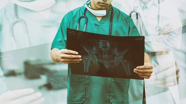 Chirurgien et médecin regardant un film radiographique . — Photo
